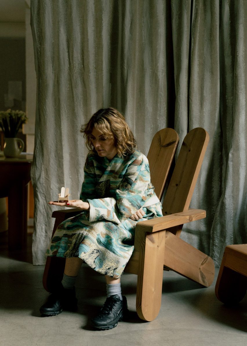 Designer Faye Toogood sitting in a wooden chair