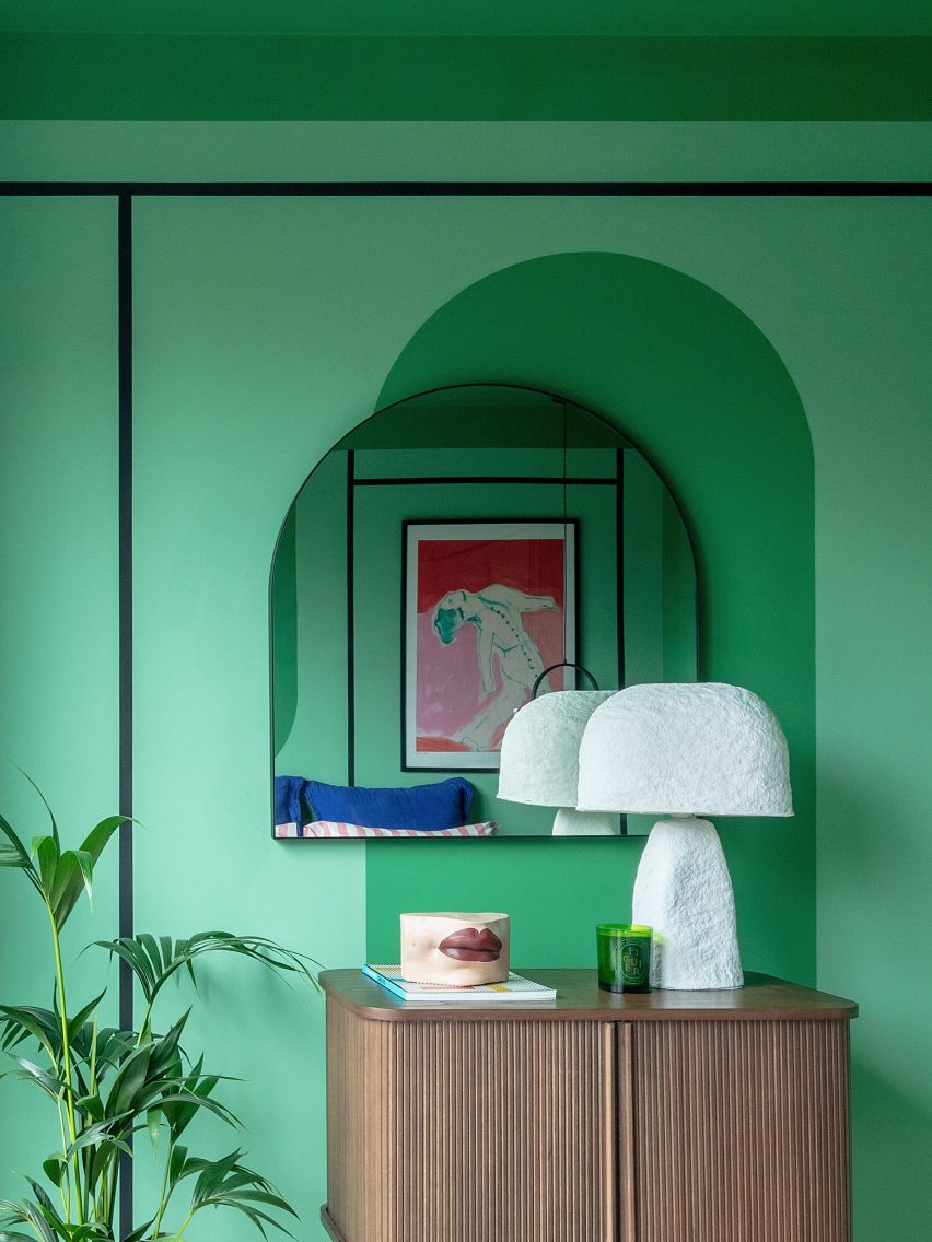 Green wall and arched mirror in Moroccan-inspired townhouse by PL Studio
