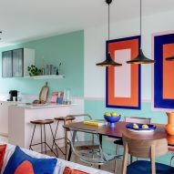 Dining table with colour wall graphics in townhouse by PL Studio