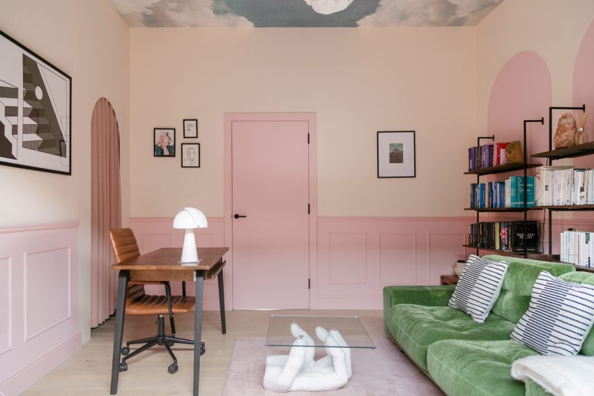 Office with pink walls and cloud graphics on ceiling