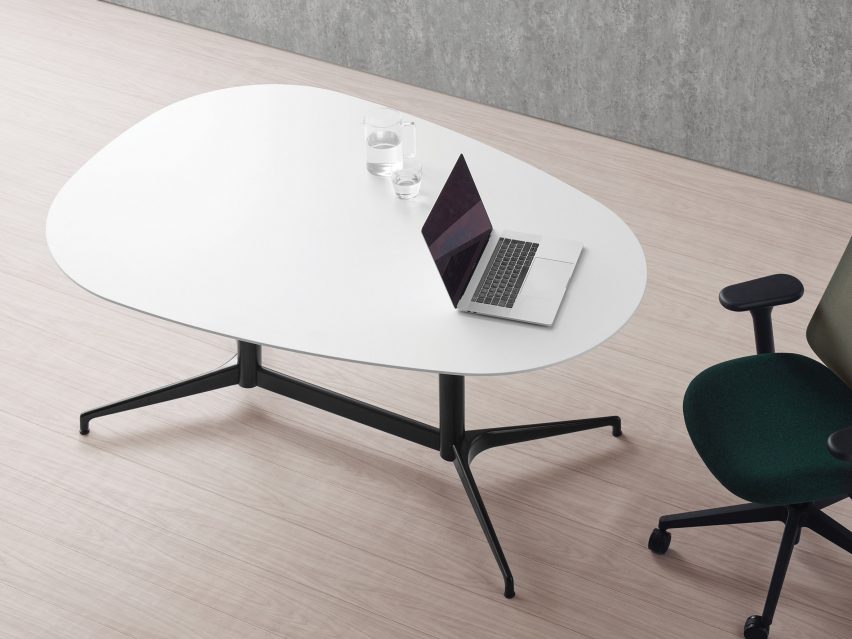 An aerial shot of a rectilinear desk with a laptop