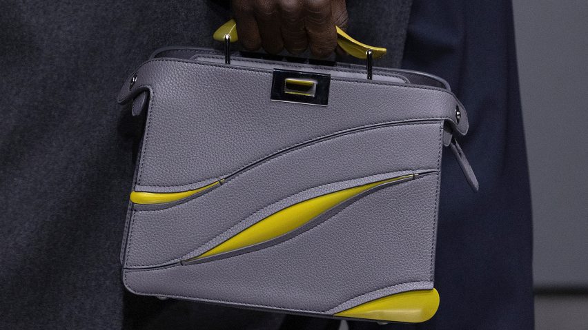 Close-up of model holding grey-and-yellow Peekaboo bag designed by Ma Yansong of MAD Architects for Fendi