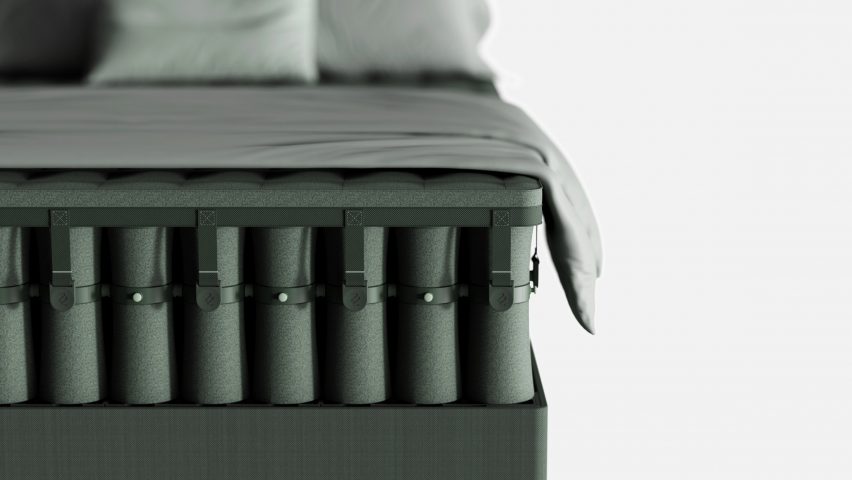 Close-up of a bed with an open mattress made of textile-covered springs stacked densely together