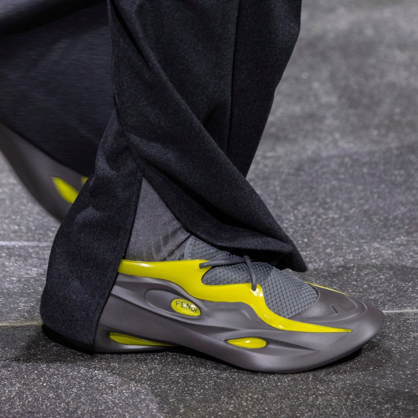 Close-up of model wearing grey-and-yellow trainers designed by Ma Yansong of MAD Architects for Fendi