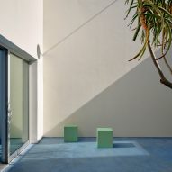 small light green stools in a courtyard