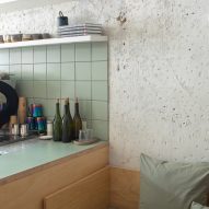 A cafe bar with seafoam green tiles and formica veneer