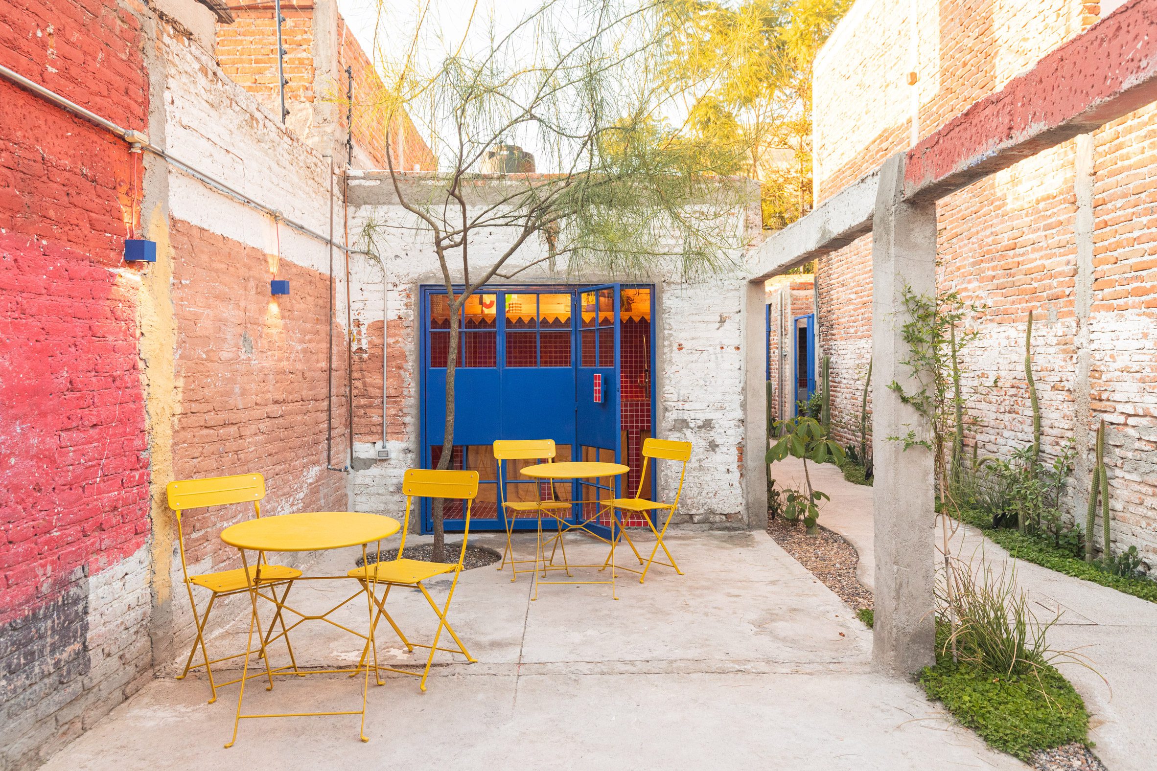 yellow chairs in front of a blue door