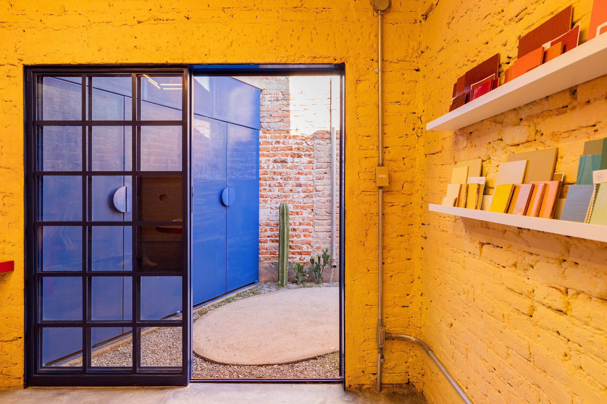 Yellow walls facing a blue colored door