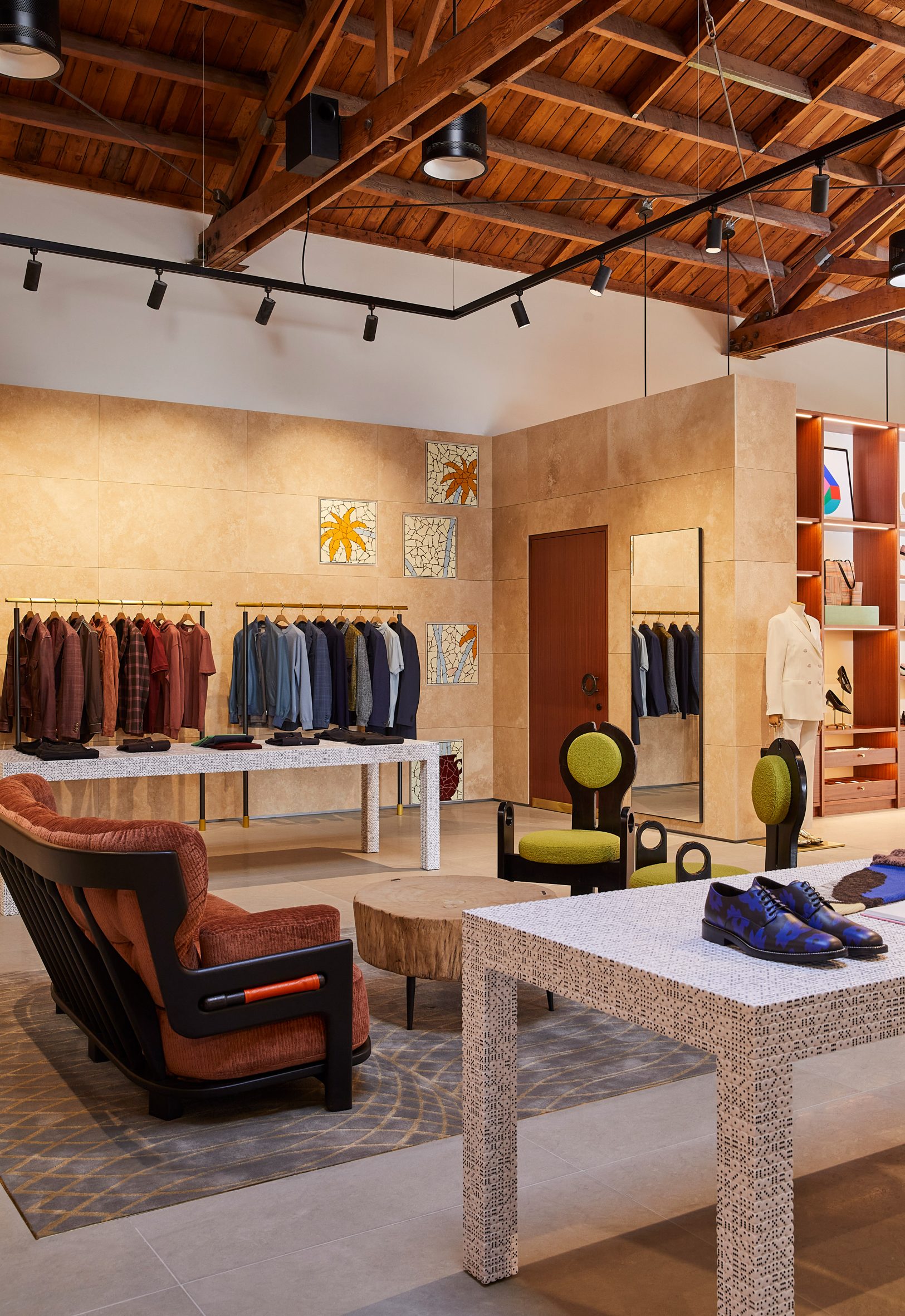 Paul Smith LA store interior is stone-clad partitions and exposed rafters