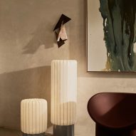 Two off-white lamps beside chair