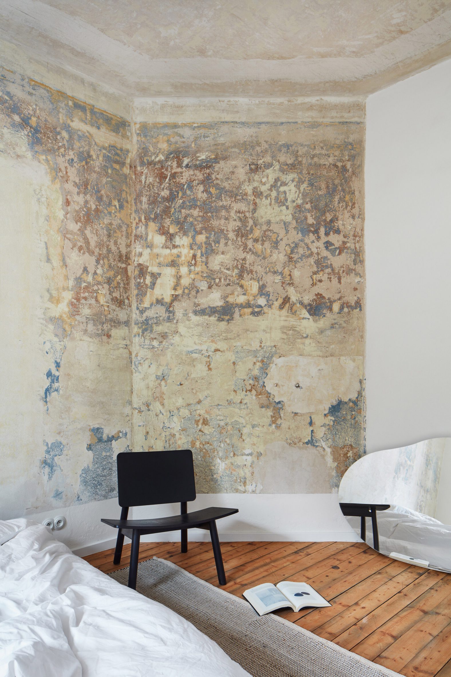 Chair in front of mottled painted wall