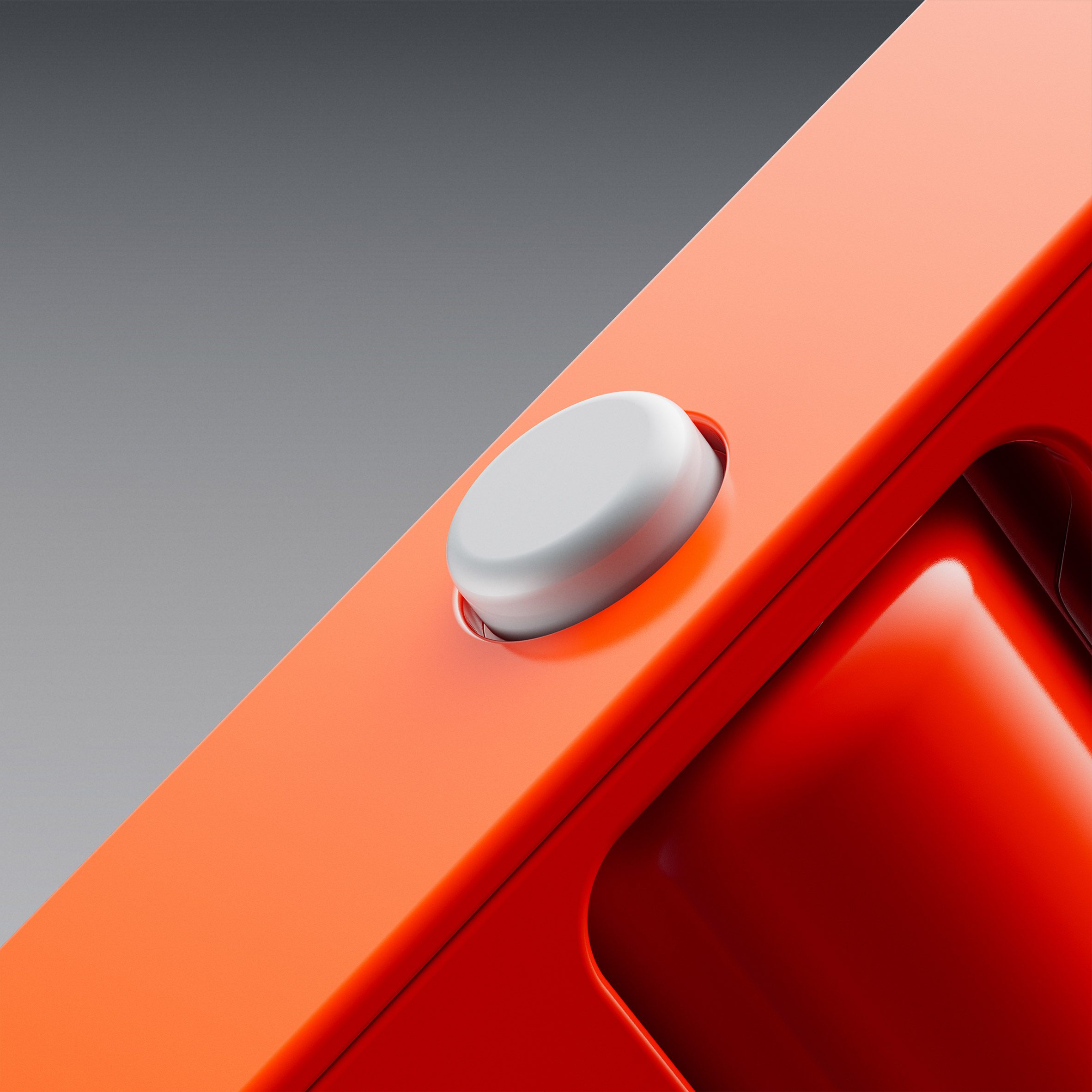 Close-up image of a small grey button on the side of a slim orange device