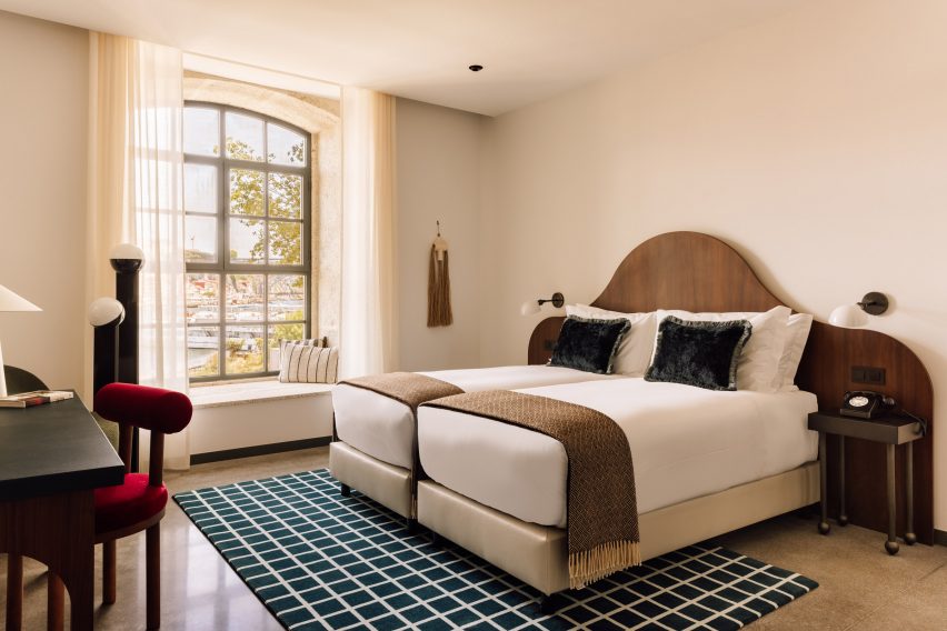 Bright bedroom with neutral decor and wavy walnut headboard