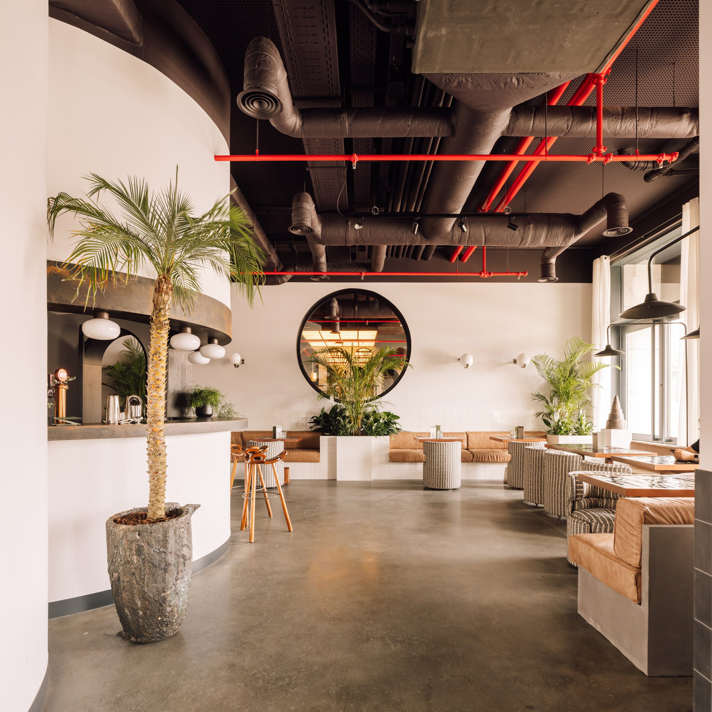 Bar and cafe area with polished concrete floors and exposed ceiling ductwork