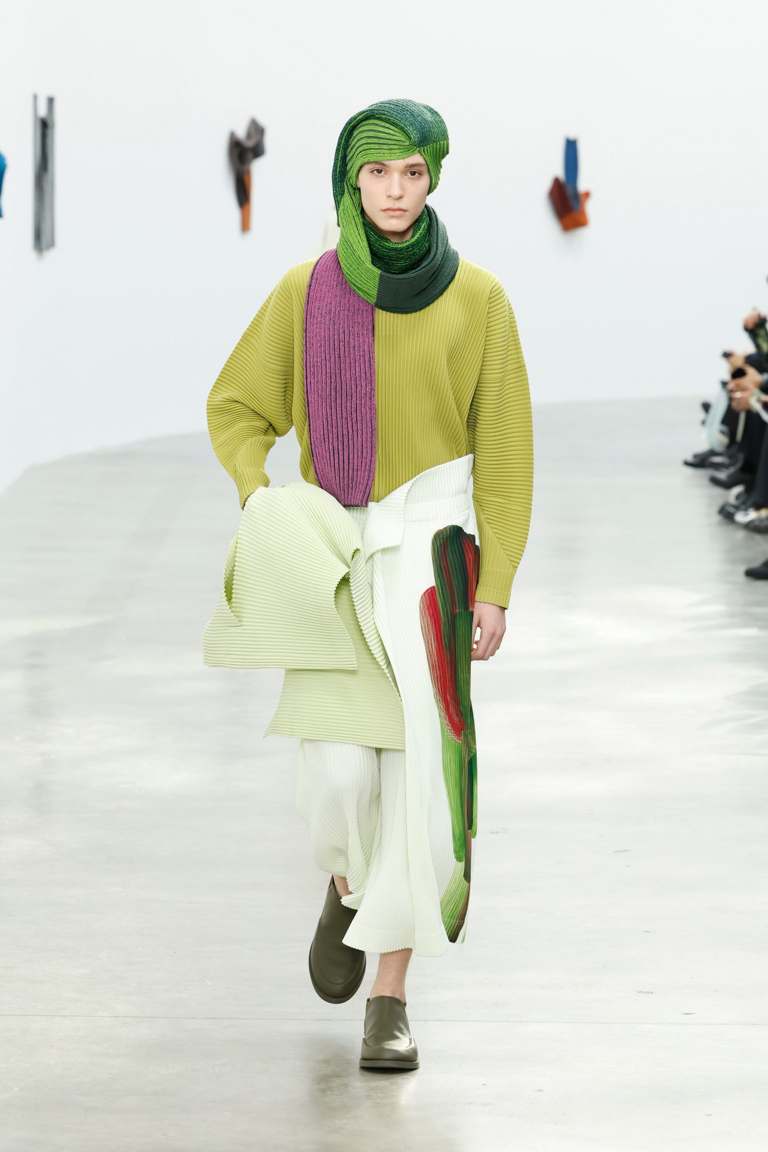 Model wearing scarf as turban from Issey Miyake Homme Plissé AW24 collection 