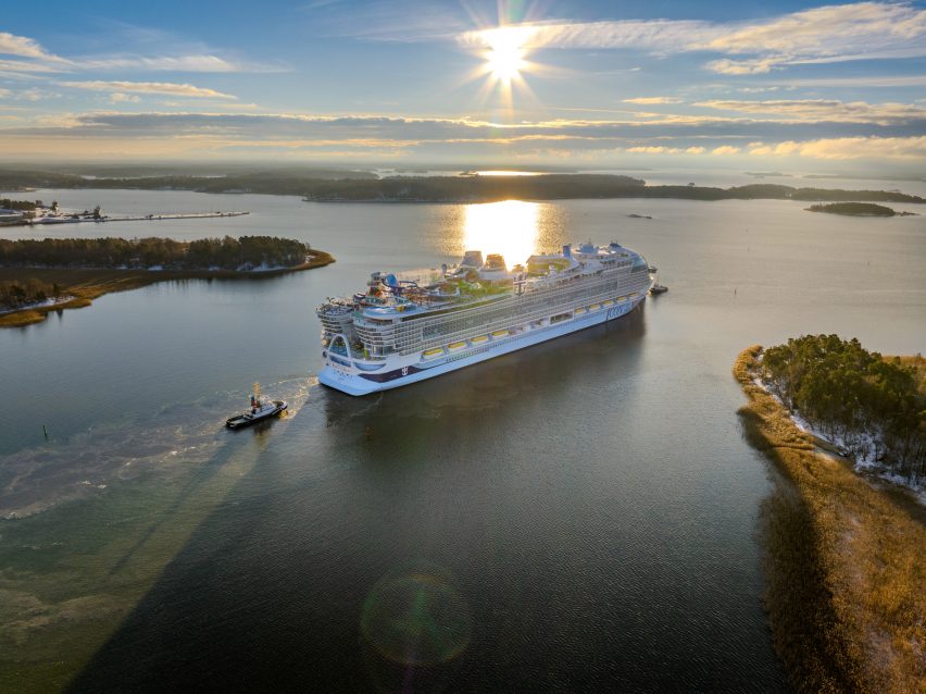Picture of a large cruise liner sailing near shoreline at sunset