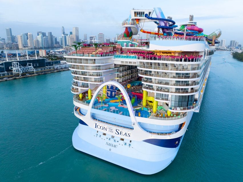 Rendering of a very large cruise ship with many decks towering over its stern, which bears the name Icon of the Seas