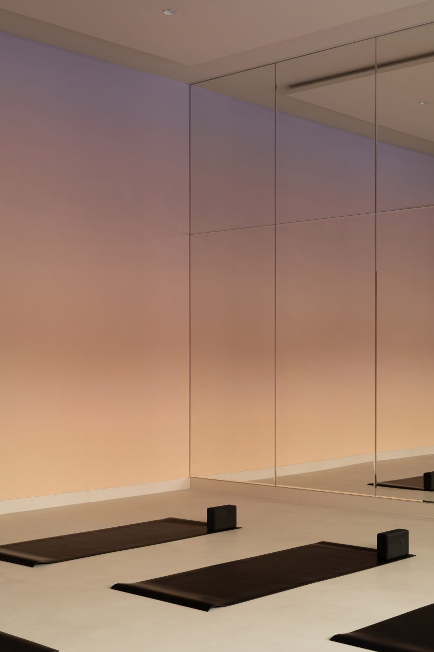 Group exercise room with gradient and mirrored wall inside Space wellness centre 
