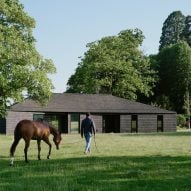 DROO adds charred-timber clubhouse to polo field in Surrey