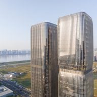 Aedas lines twin skyscrapers with bronze fins in Hangzhou