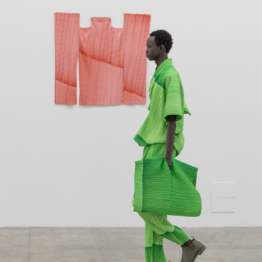 Model wearing all-green outfit from Issey Miyake Homme Plissé AW24 collection in collaboration with Ronan Bouroullec