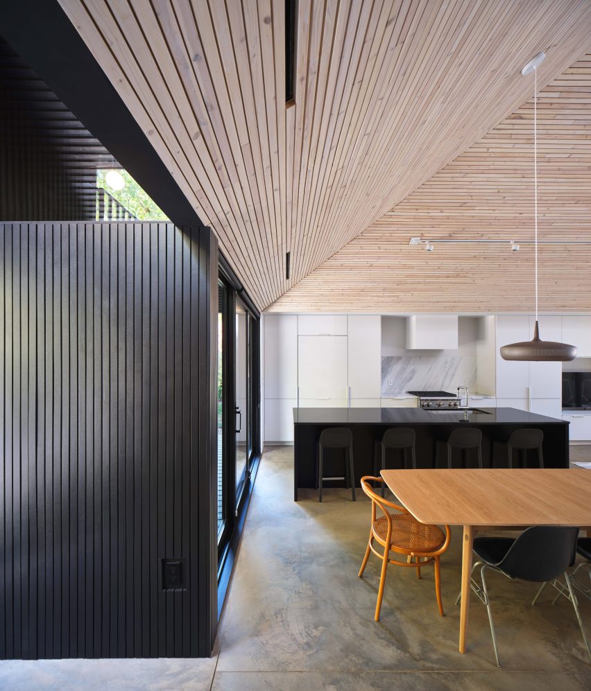Black clad wall and angled wood ceiling