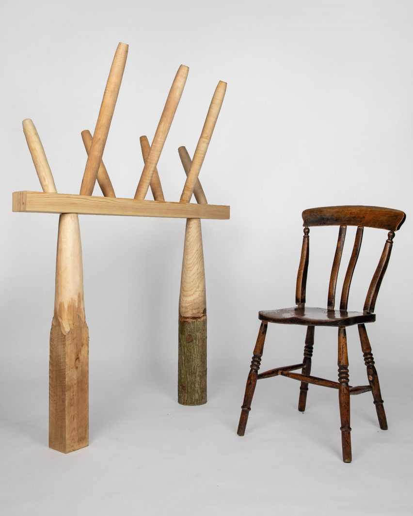 P،to of a traditional wooden chair on the right and an experimental column and beam structure topped by spindles on the left