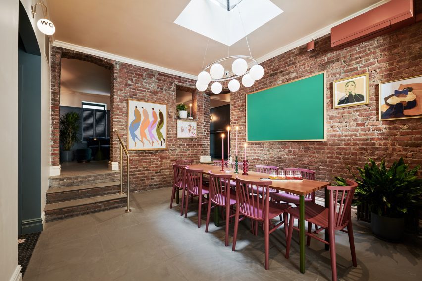 Brick-wrapped room with a skylight over a large table
