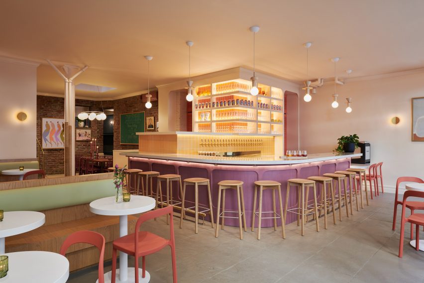 Bar area with stools surrounding a purple-fronted counter