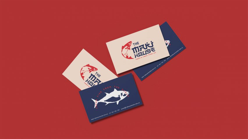 Business cards with fish on them on dark red background