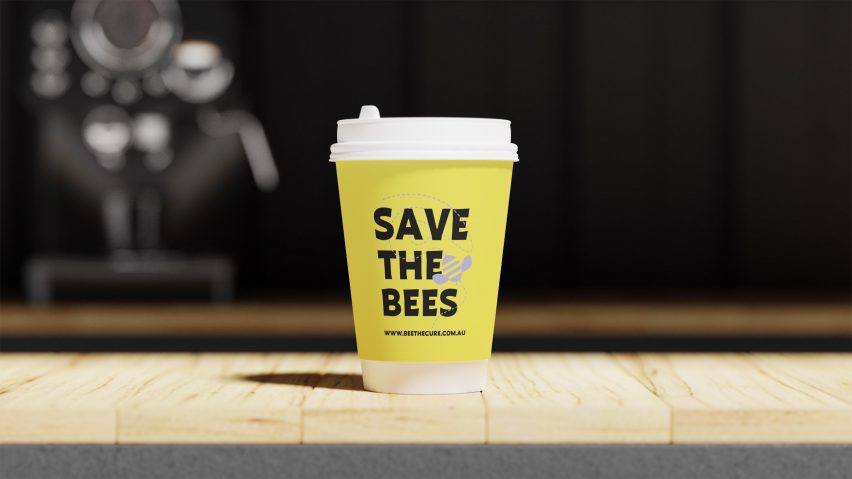 Yellow disposable coffee cup with bee on it
