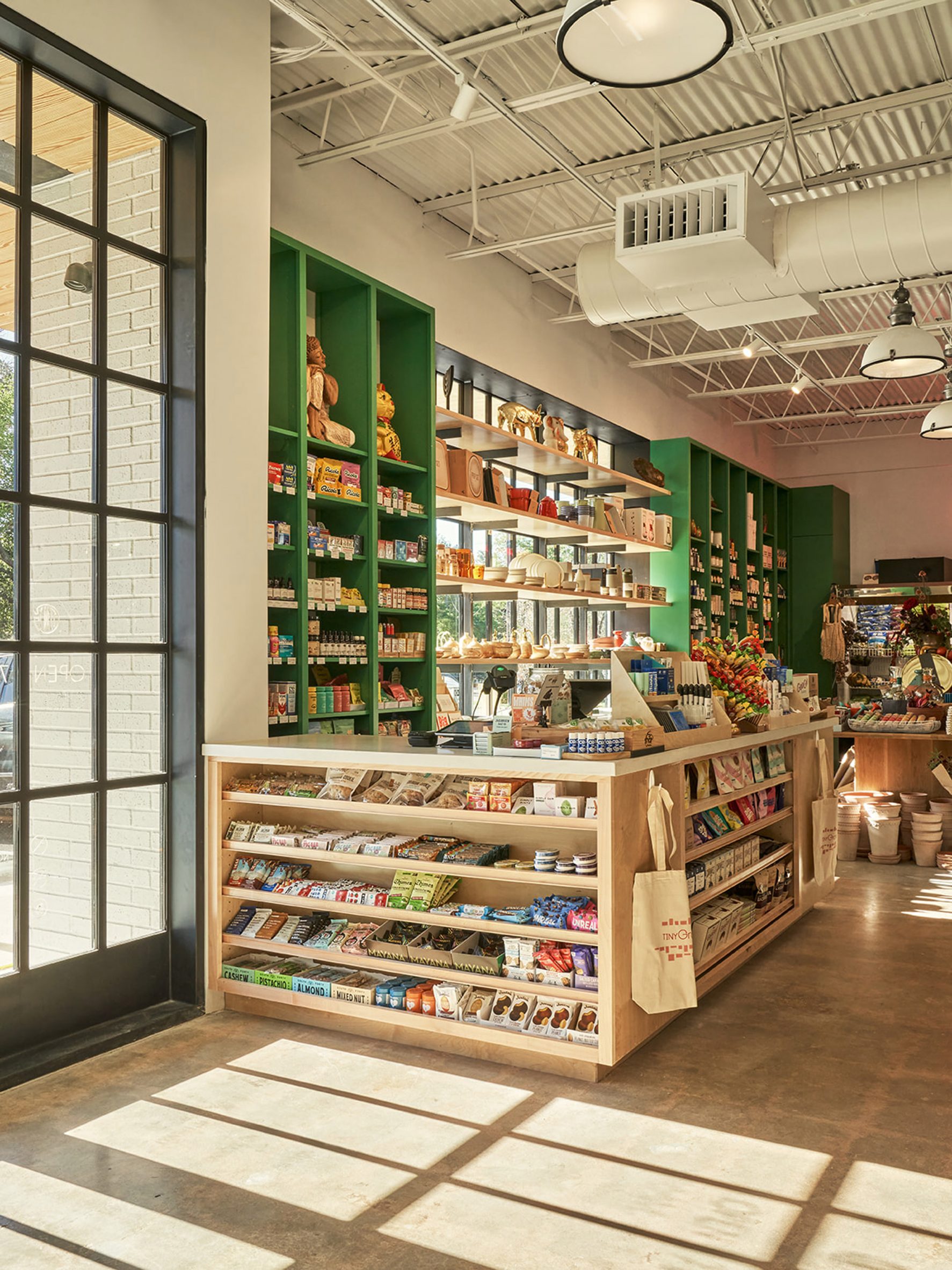 A grocery market with green shelving