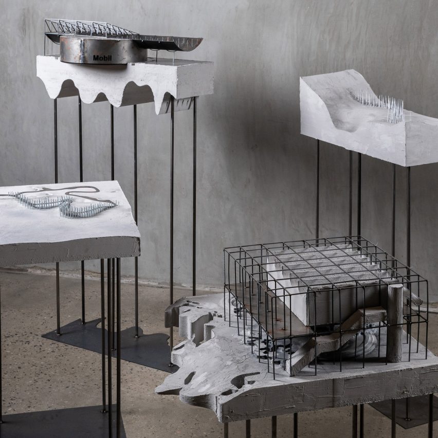 Four architectural models on plinths made from concrete and metal