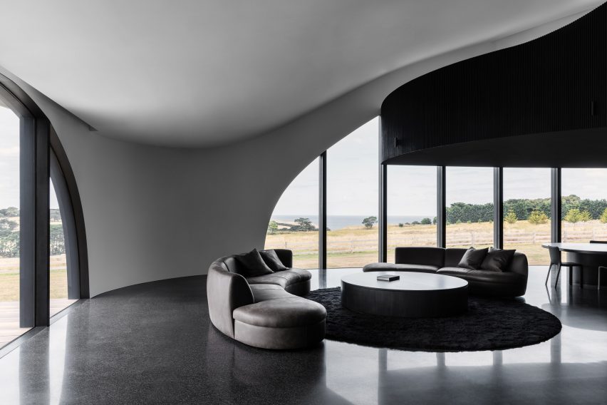 Black living room with curvaceous walls and ceiling