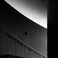 Staircase with black timber walls