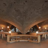 Concrete paraboloid and storage cabinet inside brutalist restaurant in Spain by Zooco Estudio