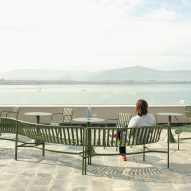 Terrace of brutalist restaurant in Spain by Zooco Estudio with green outdoor furniture