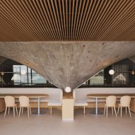 Concrete paraboloid and dining tables inside brutalist restaurant in Spain by Zooco Estudio