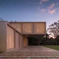 Bloco Arquitetos drapes screens over cantilevered steel house in Brazil