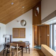 Dining room with a pitched roof and timber ceiling and floors