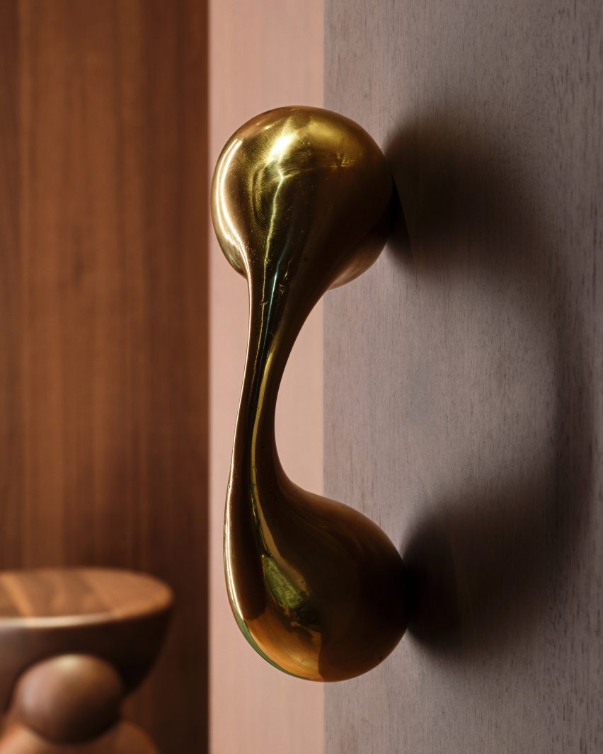 Close-up of a polished metal sculptures that forms a door pull