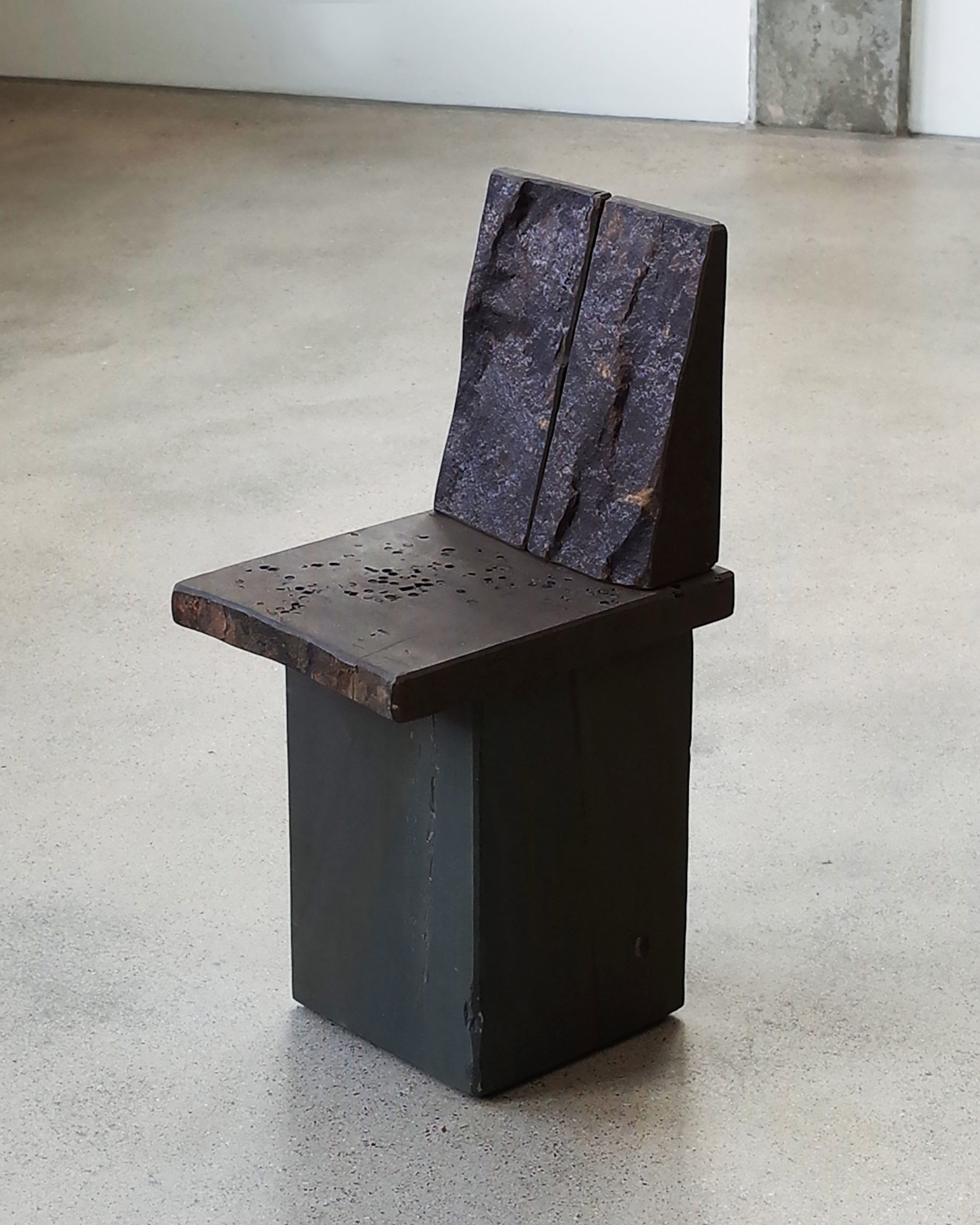 Dark-coloured sandstone chair