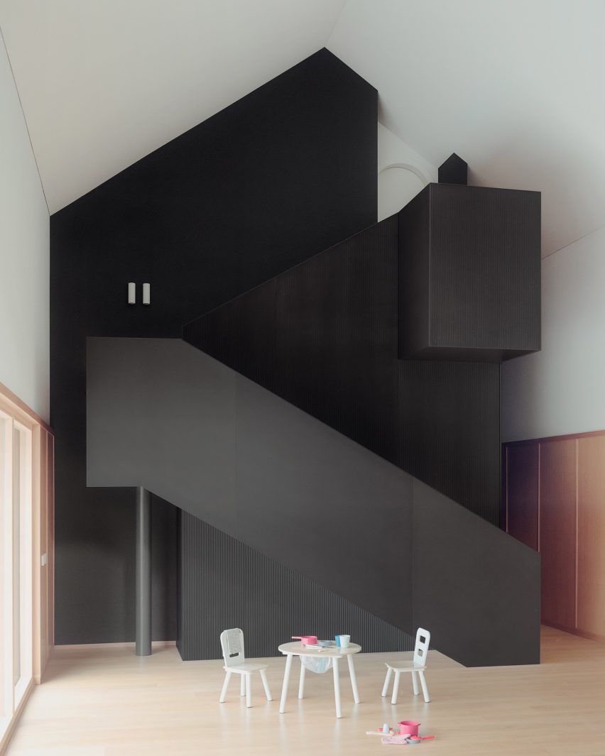 View of internal staircase at cork-clad home by LCA Architetti