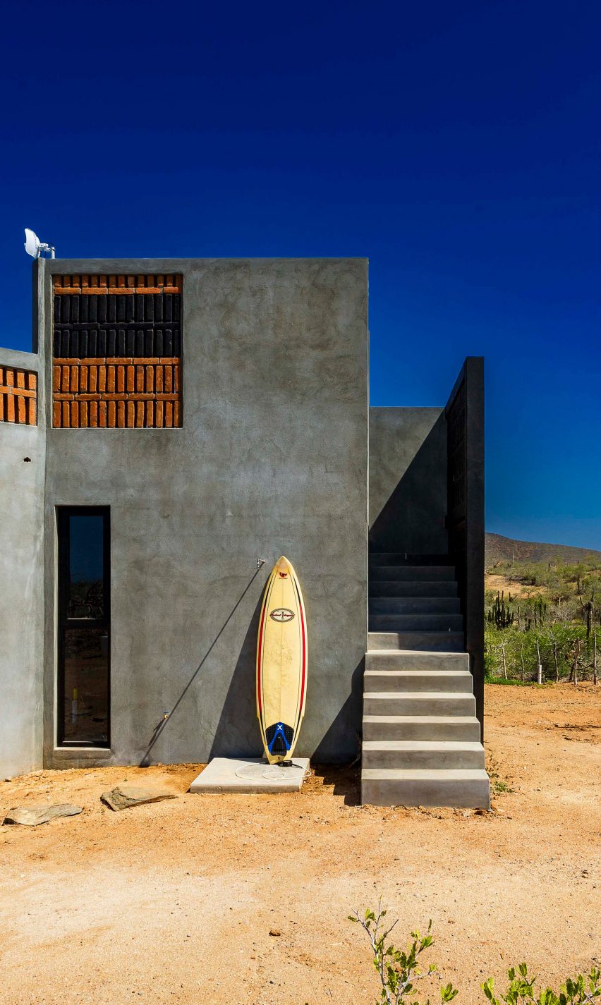 Concrete home with surfboard