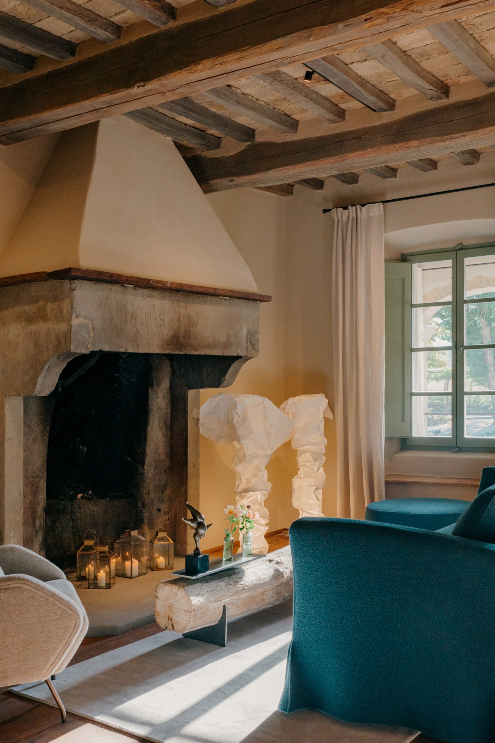 Seating area with fireplace inside Hotel Vocabolo Moscatelli in Umbria by Archiloop