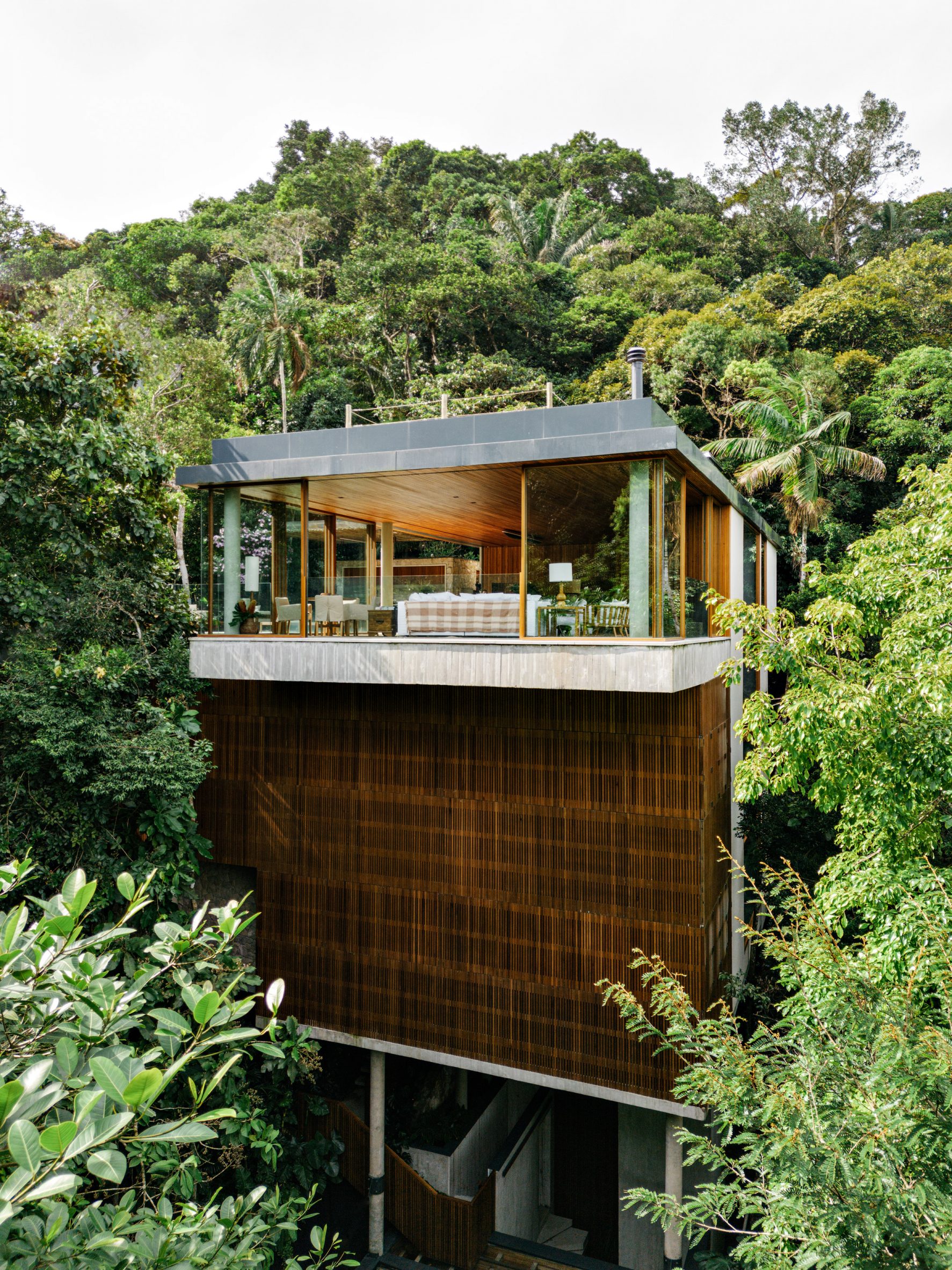 Rectilinear wood-clad home on hillside