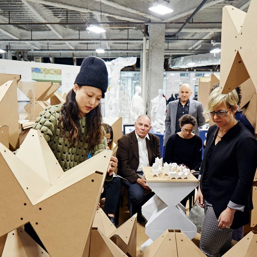 a photograph of a group of people viewing design work