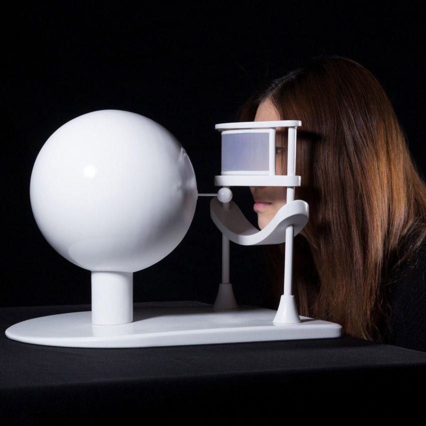 a photograph of a person interacting with an abstract white device
