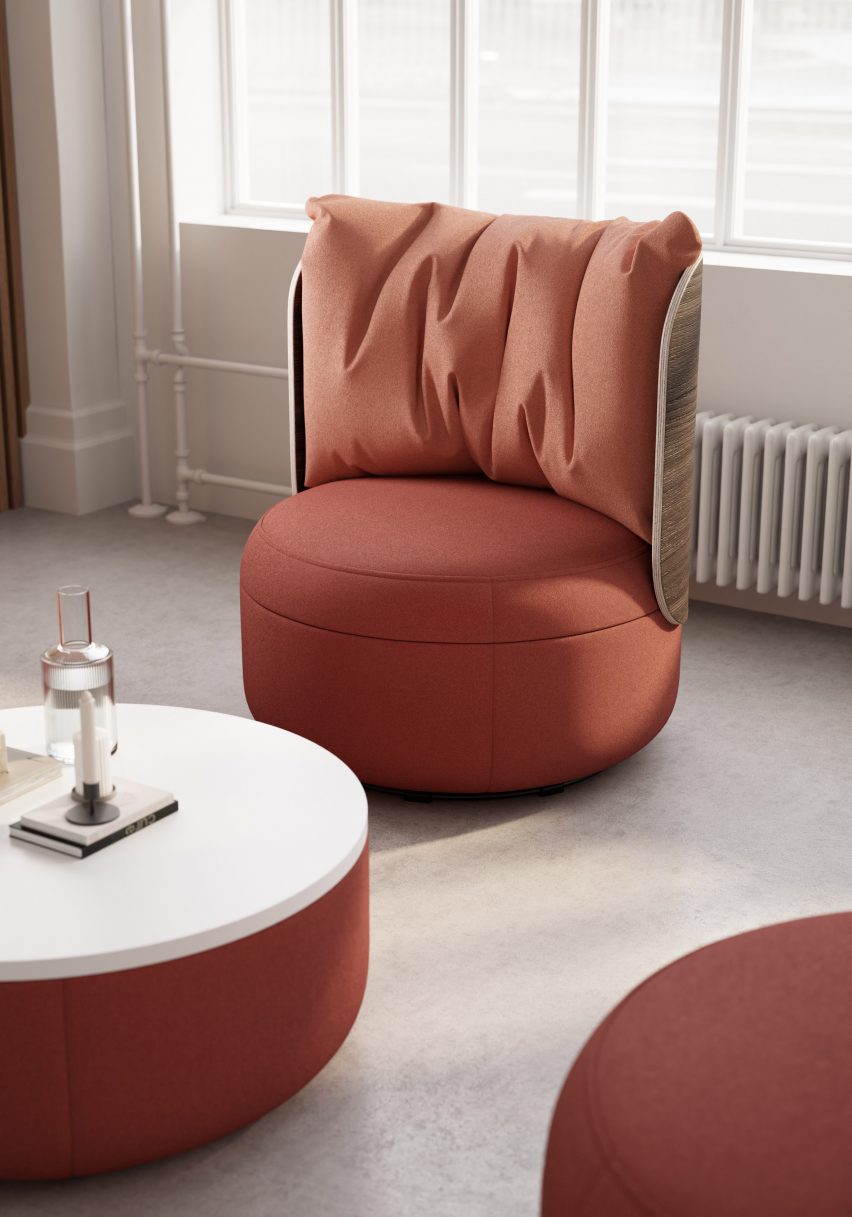 A curvilinear lounge chair from KFI Studio's Dotti collection with coral upholstery