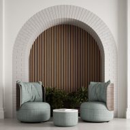 Two curvilinear lounge chairs from KFI Studio's Dotti collection with pale blue upholstery